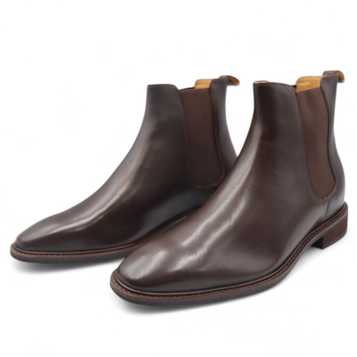 Pair of brown leather Chelsea boots on a white background