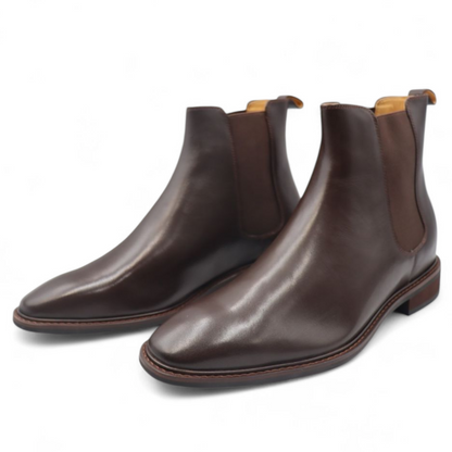 Pair of brown leather Chelsea boots on a white background