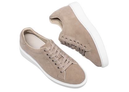 Beige sneakers on a white background