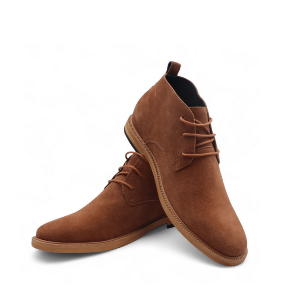 Brown suede boots on a white background