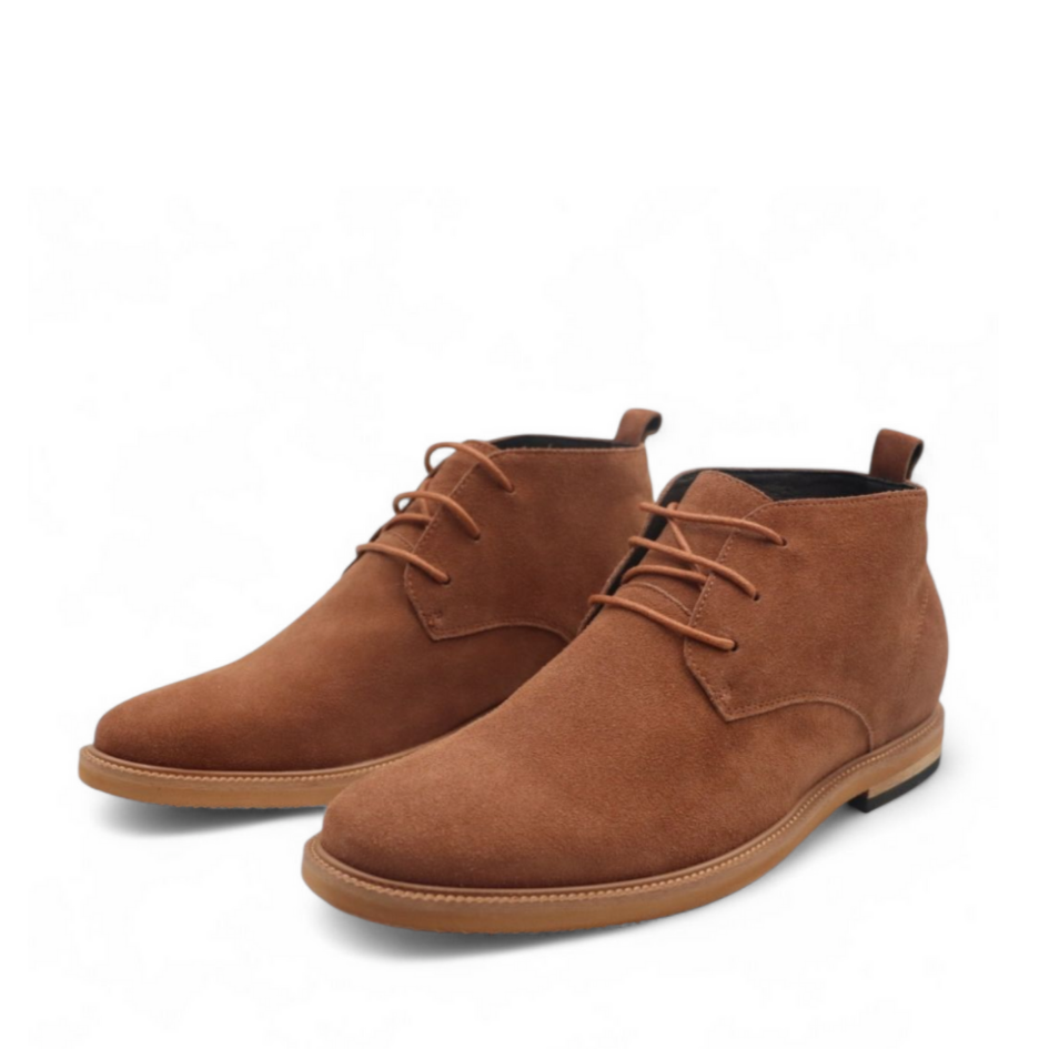 Pair of brown suede boots on a white background