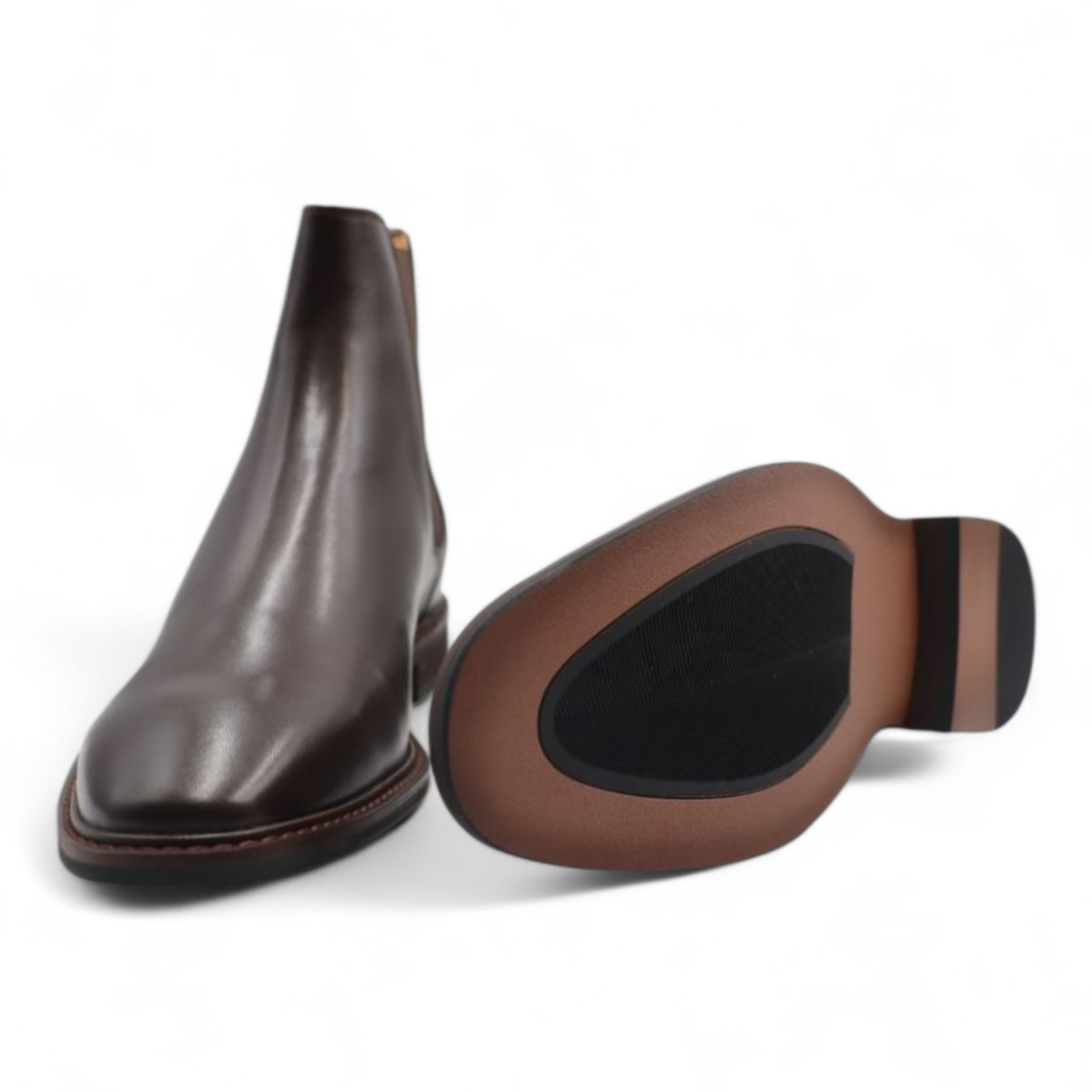 Brown leather ankle boot and shoe insole on a white background