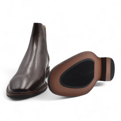 Brown leather ankle boot and shoe insole on a white background