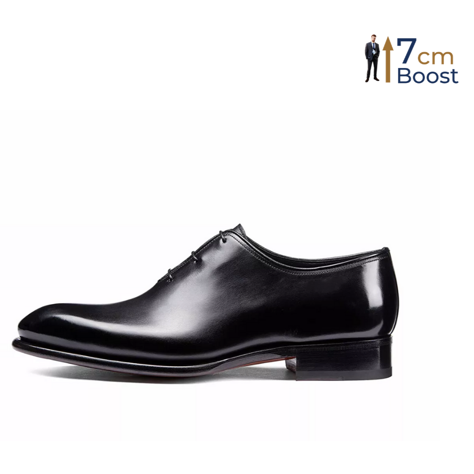 A black leather dress shoe with a polished finish, featuring a lace-up closure and a subtle heel boost for height