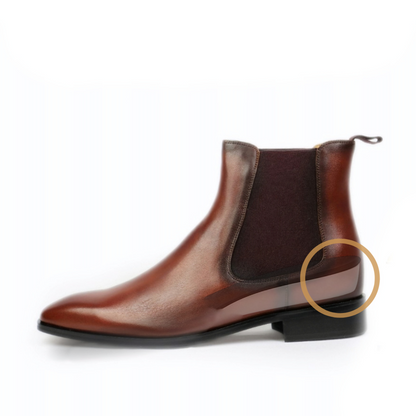 Brown leather Chelsea boot on a white background with a gold circle highlighting the sole.
